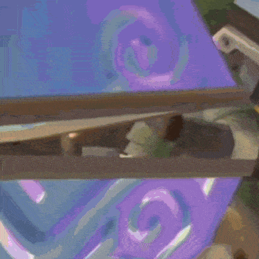 a purple swirl is visible in the background of a painting