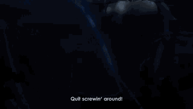 a blurry picture of a person standing next to each other in a dark room .