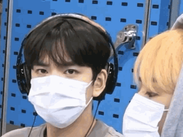 a man wearing a face mask and headphones