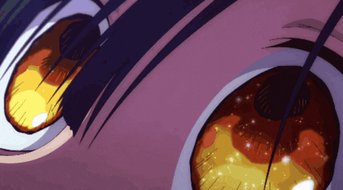 a close up of a person 's eyes with glowing yellow and orange eyes