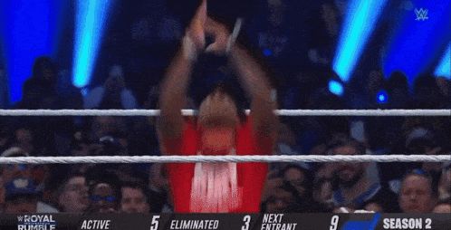 a red shirt with the letter l on it is in a boxing ring