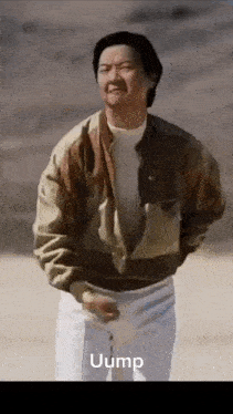 a man in a brown jacket and white pants is standing on a beach with the word uump on the bottom