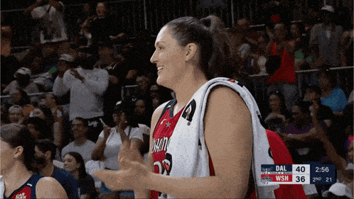 a female basketball player wearing a jersey that says washington