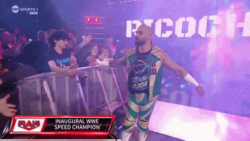 a man in a green and gold outfit is walking into a wrestling ring