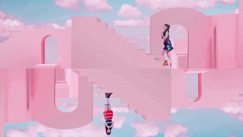 a girl is doing a handstand while another girl stands on a pink staircase