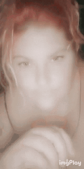 a blurry picture of a woman 's face with the words imgplay below