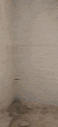 a blurred image of a white wall with a few lines on it