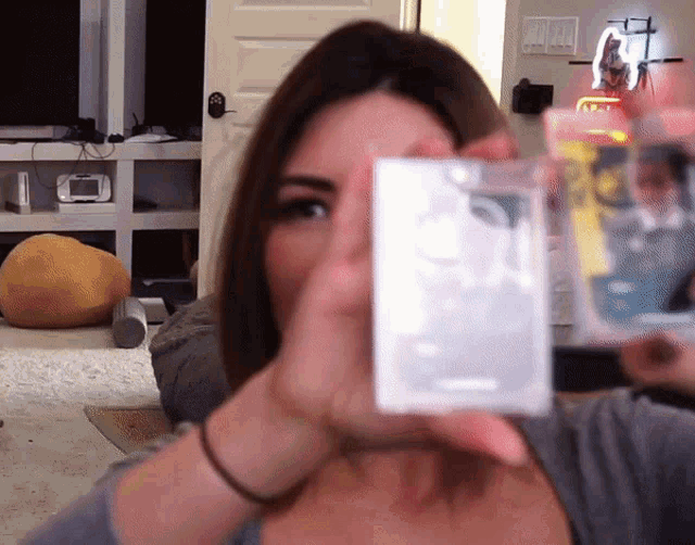 a woman is holding a box with a picture of a person on it