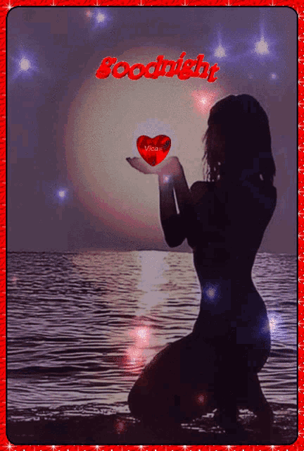 a silhouette of a woman kneeling in the water holding a red heart with the words goodnight written above her