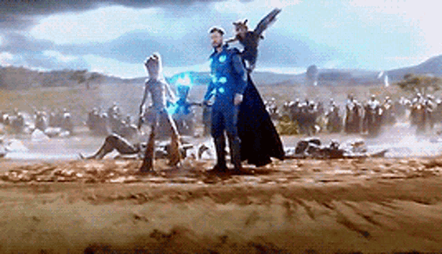 doctor strange , thor , and groot are standing in a field with a group of people .