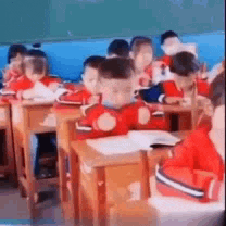a group of children are sitting in a classroom .