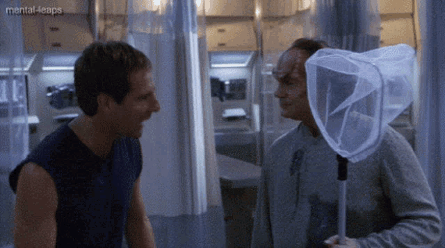 two men are standing next to each other and one has a net on his head ..