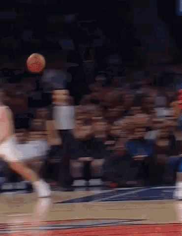 a blurry photo of a basketball player dribbling a ball