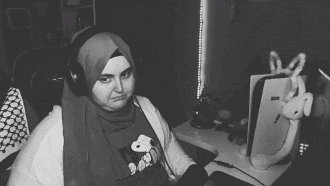 a black and white photo of a woman wearing headphones and a shirt that says snoopy