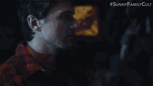 a man and a woman are kissing in a dark room in sunny family cult .