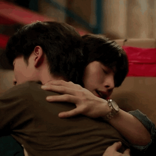 a man wearing a watch hugging another man