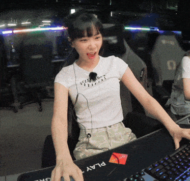 a woman wearing a white t-shirt that says " play " on it