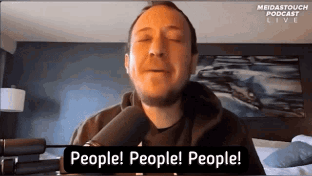 a man is talking into a microphone with the words people people people behind him