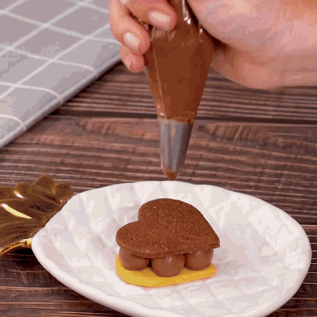 a white plate has a heart shaped cookie on it