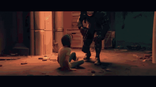 a man is kneeling down next to a girl in a dark room