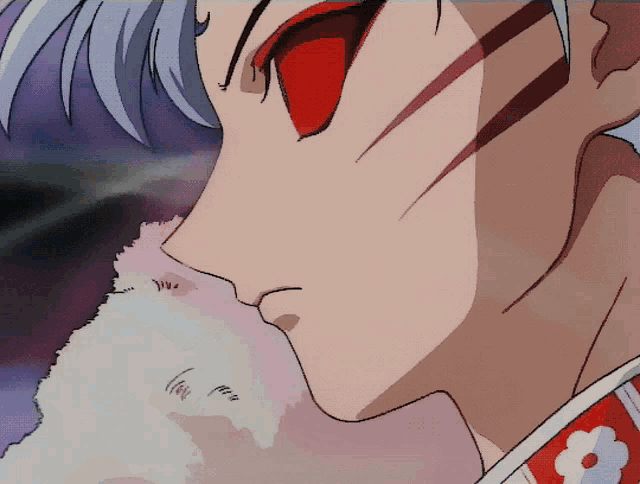 a close up of a man 's face with red eyes
