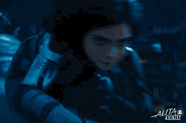 a close up of a woman 's face with the words alita army above her