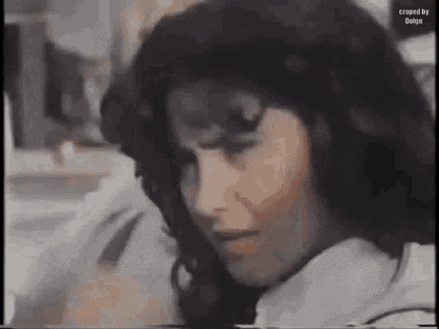 a close up of a woman 's face in a black and white video .