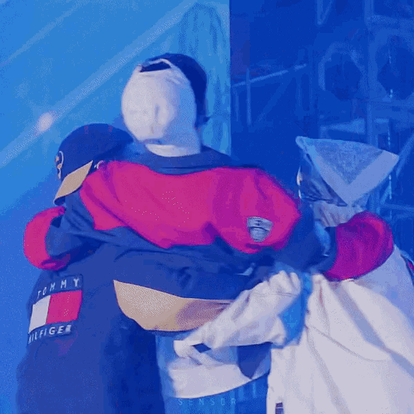 a tommy hilfiger jacket is being hugged by two people