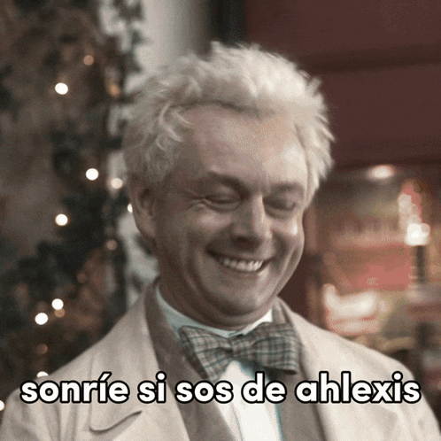 a man wearing a bow tie is smiling with the words sonrie si sos de ahlexis written below him