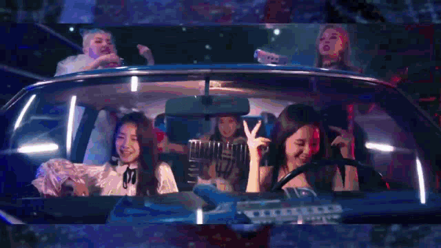 a group of people are sitting in a car and one of them is making a funny face