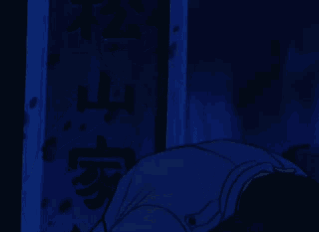 a man in a suit and tie is being held by another man in a dark room