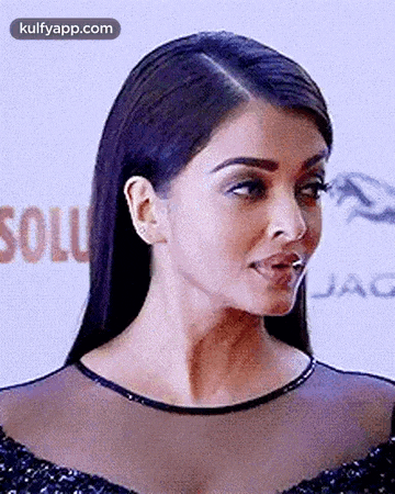 a close up of a woman 's face with her mouth open and a blurred background .
