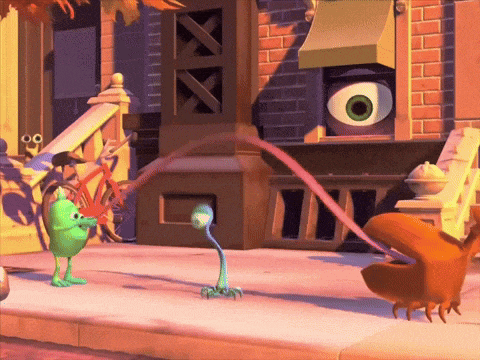 a cartoon character with a large eye is standing on a sidewalk