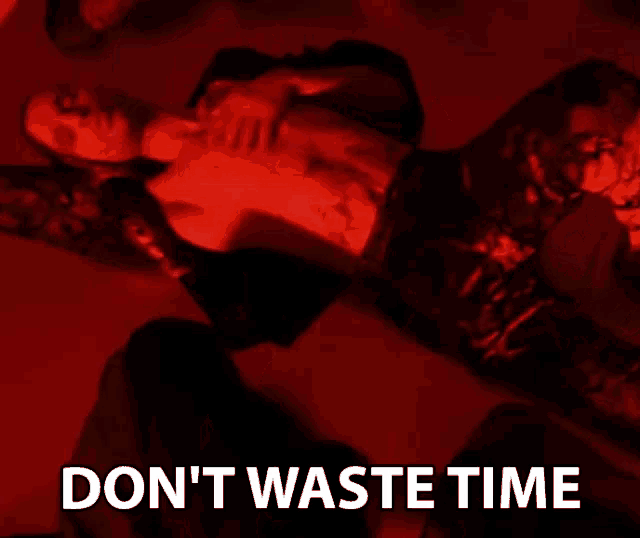 a shirtless man laying on the floor with the words " don 't waste time " written below him