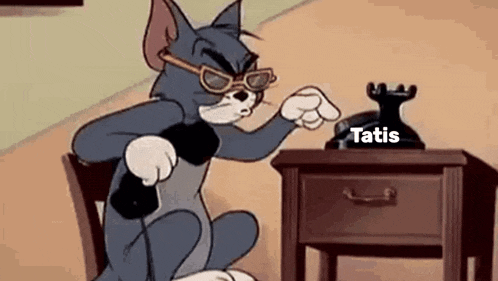 a cartoon cat is sitting in a chair talking on a phone .