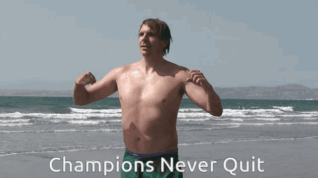 a shirtless man flexes his muscles on a beach with the words champions never quit below him