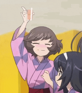 a girl in a kimono is holding a drink in her hand and making a funny face .