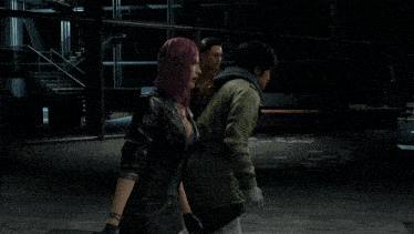 a man and a woman are standing next to each other in a video game