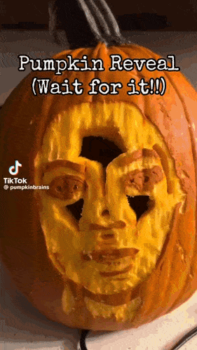 a pumpkin with a face carved into it that says pumpkin reveal wait for it