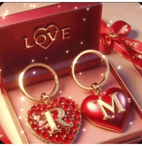 two heart shaped keychains with the letter r and m on them