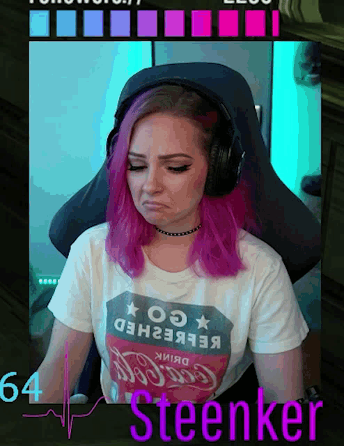 a girl with pink hair is wearing a coca cola shirt