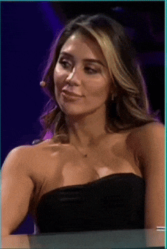 a woman in a black strapless dress is smiling