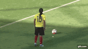 a soccer player wearing a yellow jersey with the number 19 on the back