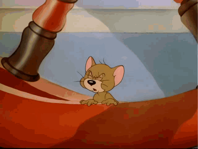 a cartoon cat is sitting on a red carpet
