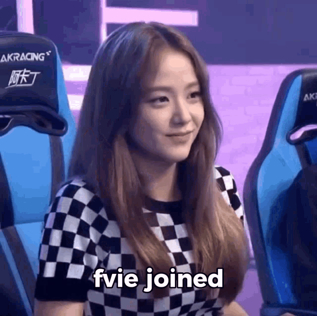 a woman in a checkered shirt is sitting in a chair with the words fvie joined written below her .