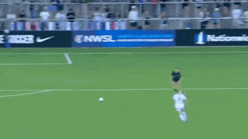 a soccer game is being played in front of a sign that says ' nwls watch live matches '