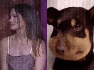 a woman is standing next to a stuffed animal that looks like a dog .