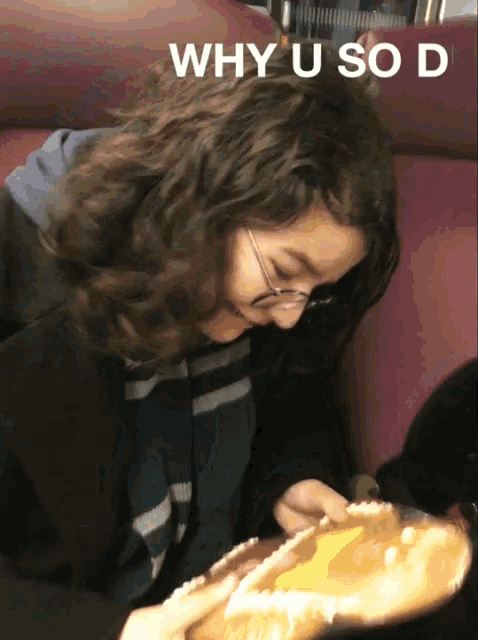 why u so d is written above a woman eating a sandwich