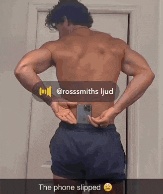 a shirtless man is taking a picture of himself with a phone in his pocket