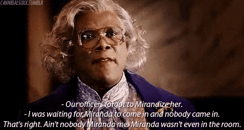 a woman wearing glasses and a purple jacket is talking to a man .